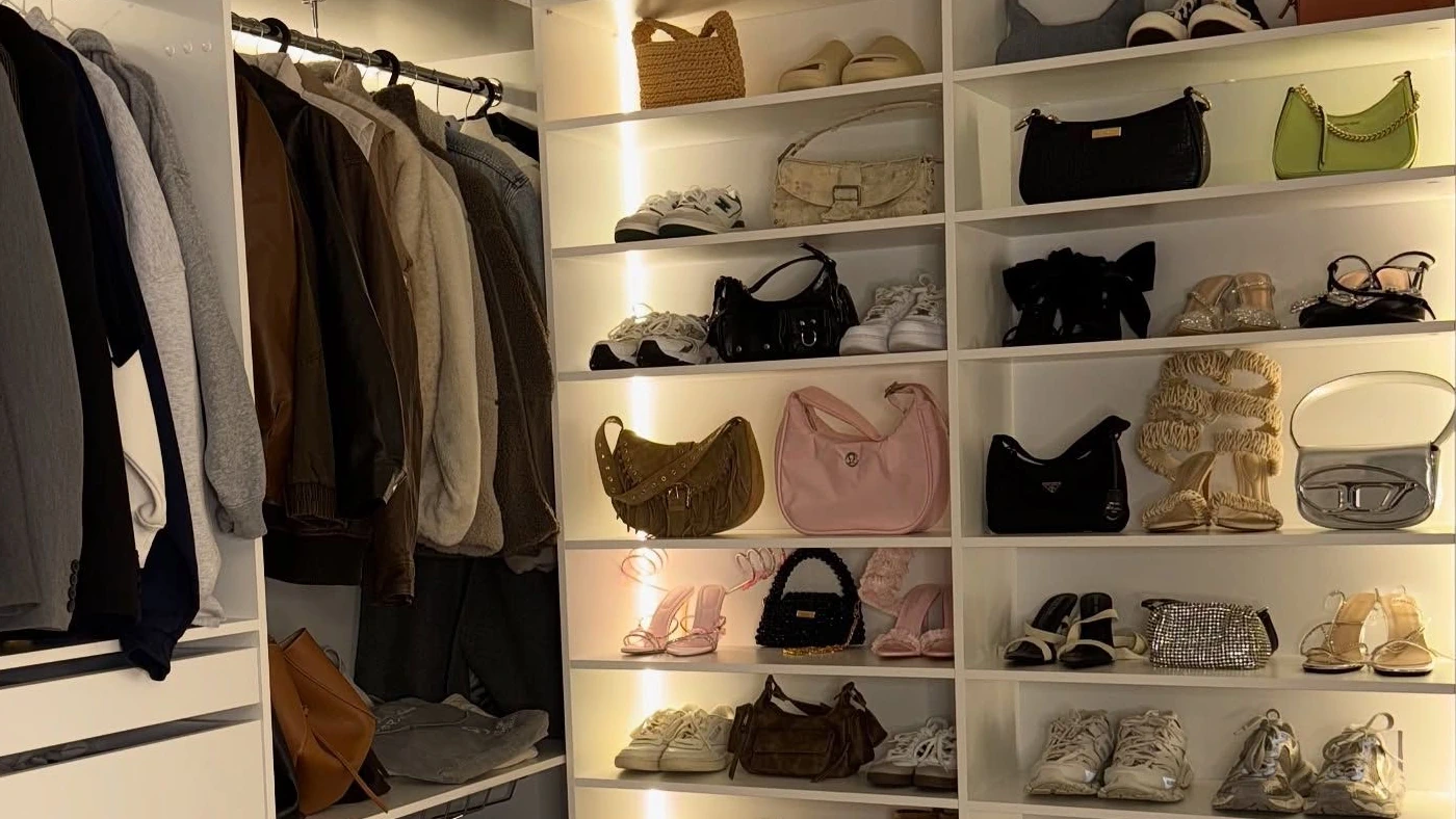 A small rail of neatly arranged clothes in a calm colour palette