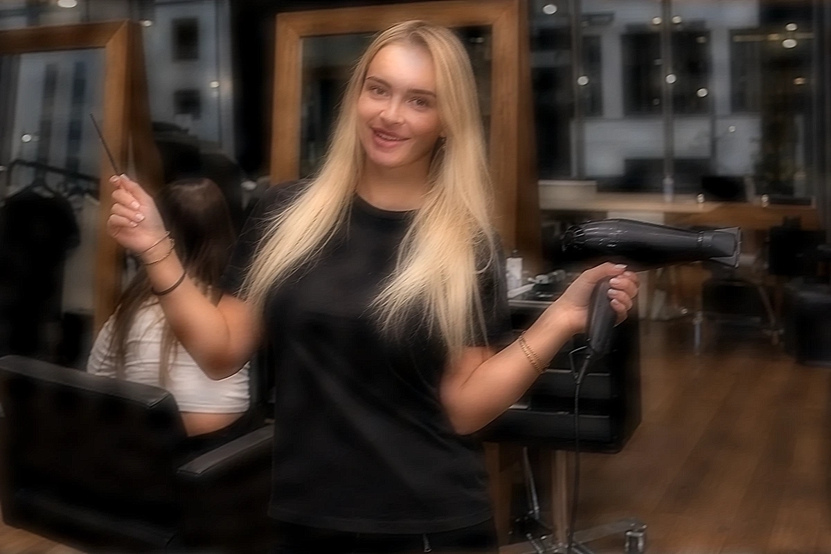 Hannah Brooks going through a rail of clothes with a client